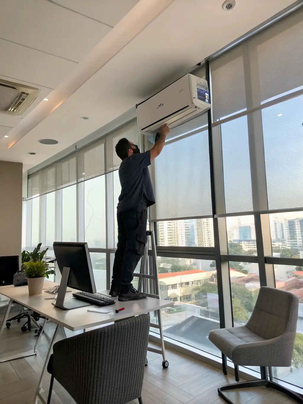 A professional technician installing a modern, energy-efficient air conditioning unit in a clean, well-lit residential living room. The focus is on the precision and care taken during the installation process.